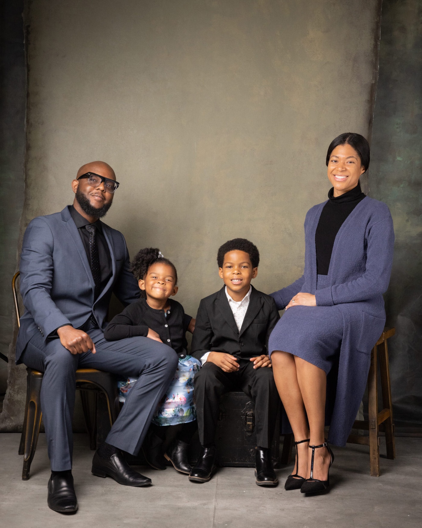 Parents and two children together in a studio portrait