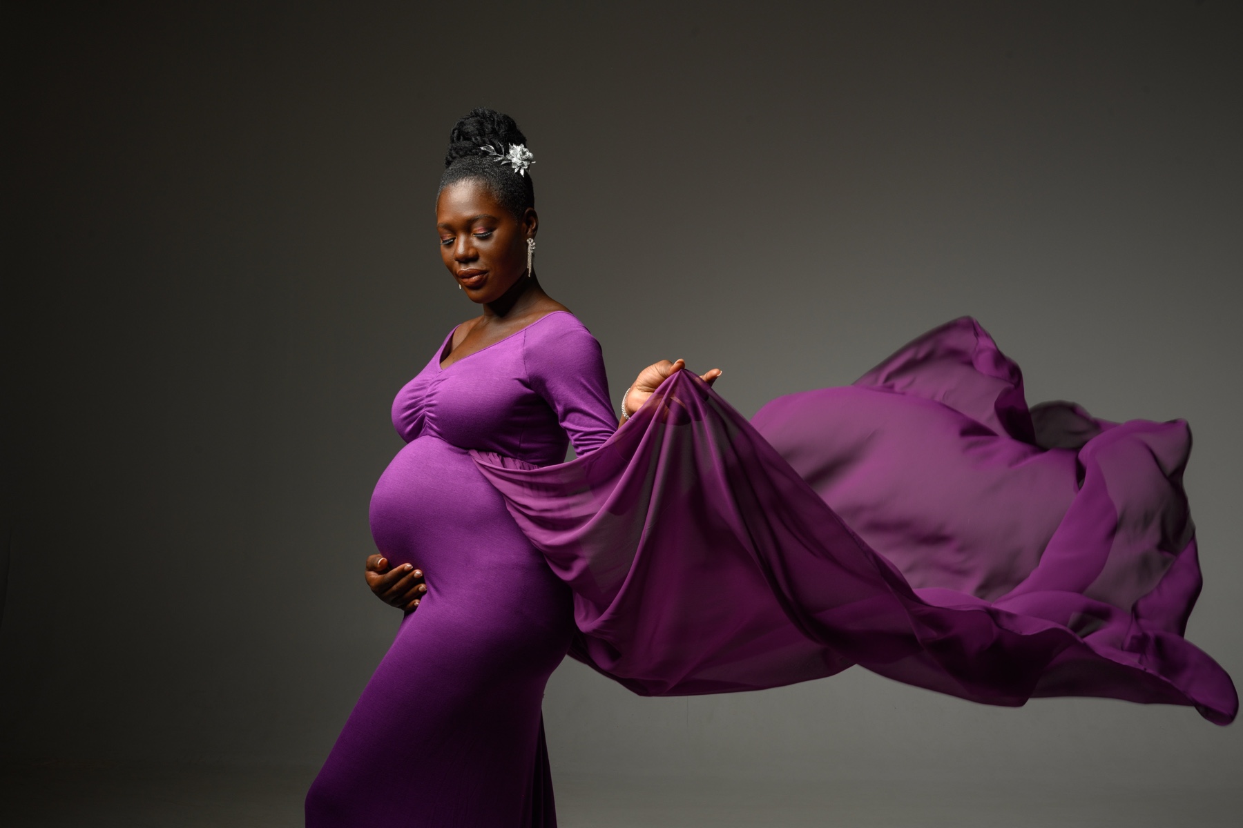 Expectant mother in a flowing purple dress